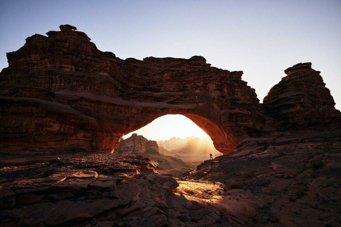 Sunset or sunrise colours shining under natural desert canyon archway