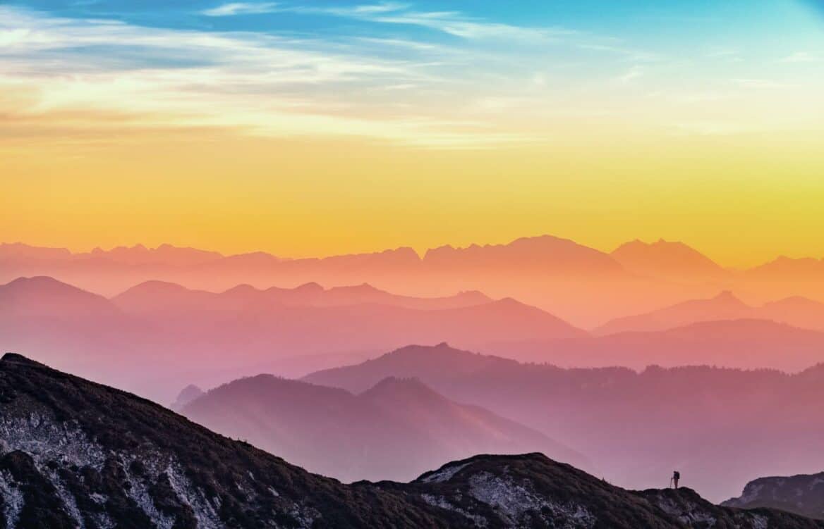 Layers of vibrant colours during sunrise.sunset, in a mountain range, illustrating different depth or distance layers
